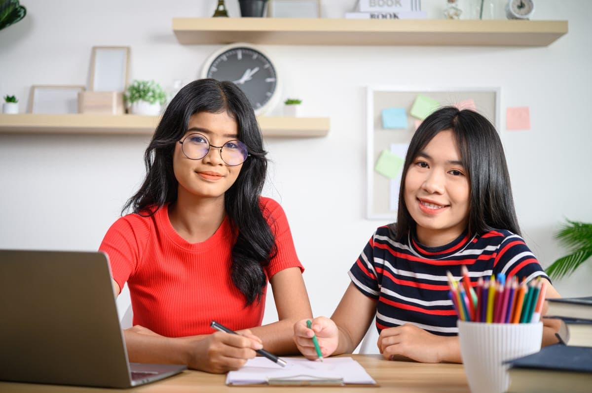 Student solving math problems with a tutor in Singapore