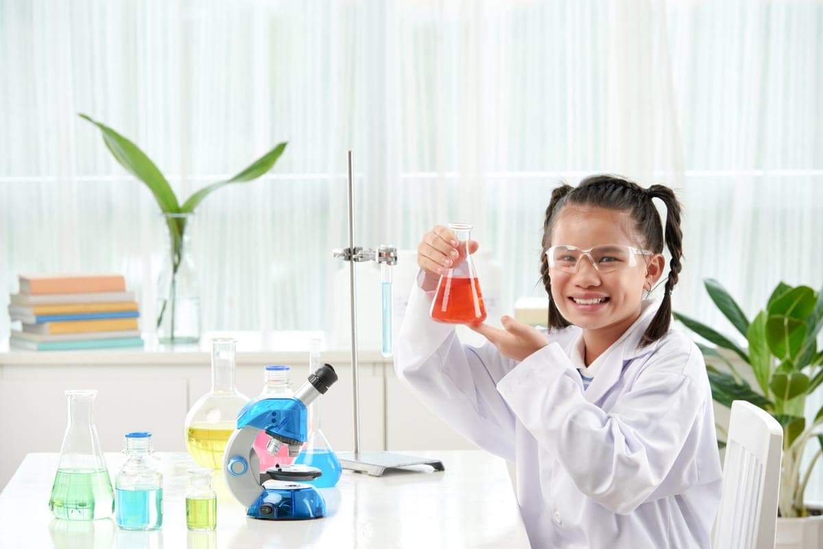 Secondary school student conducting a science experiment with tutor guidance