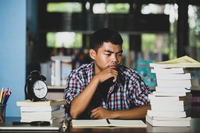 Secondary school student working through A-Math revision at a study desk in Singapore